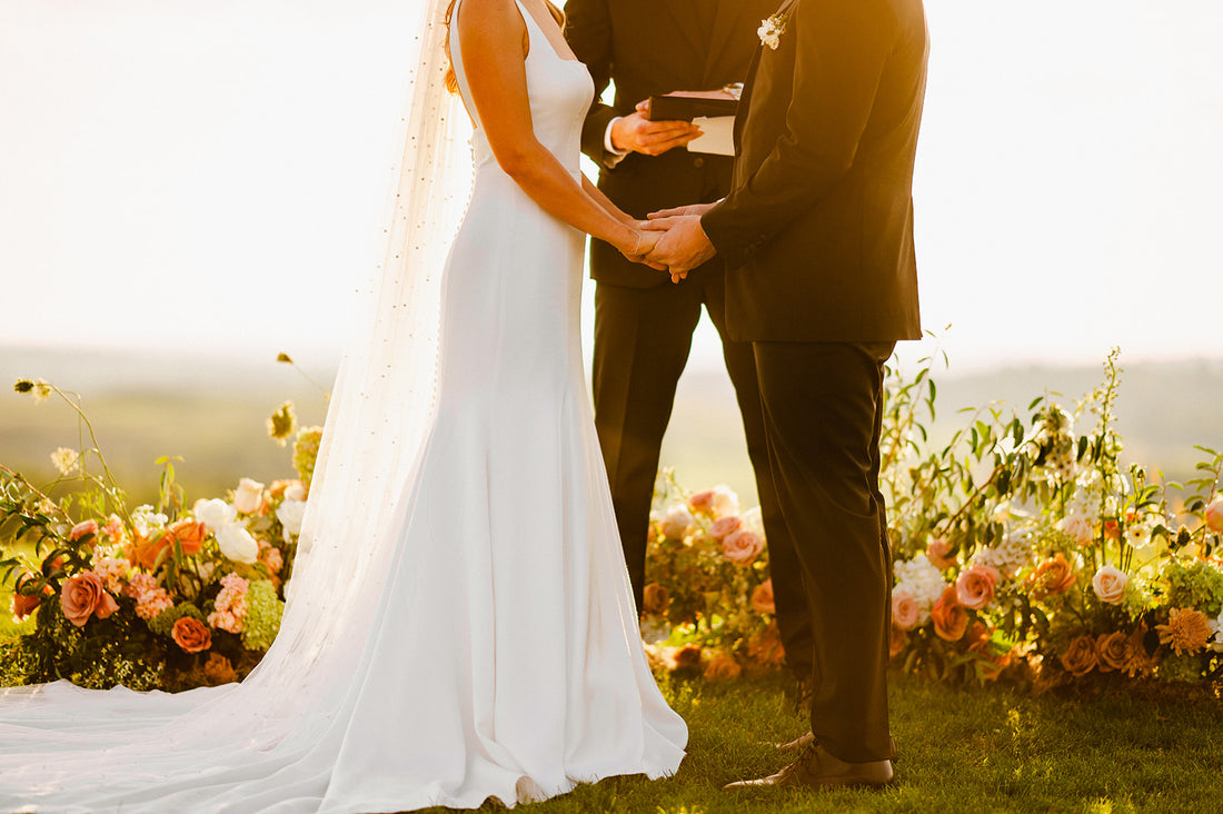 Image of ground floral arch for sunset wedding ceremony